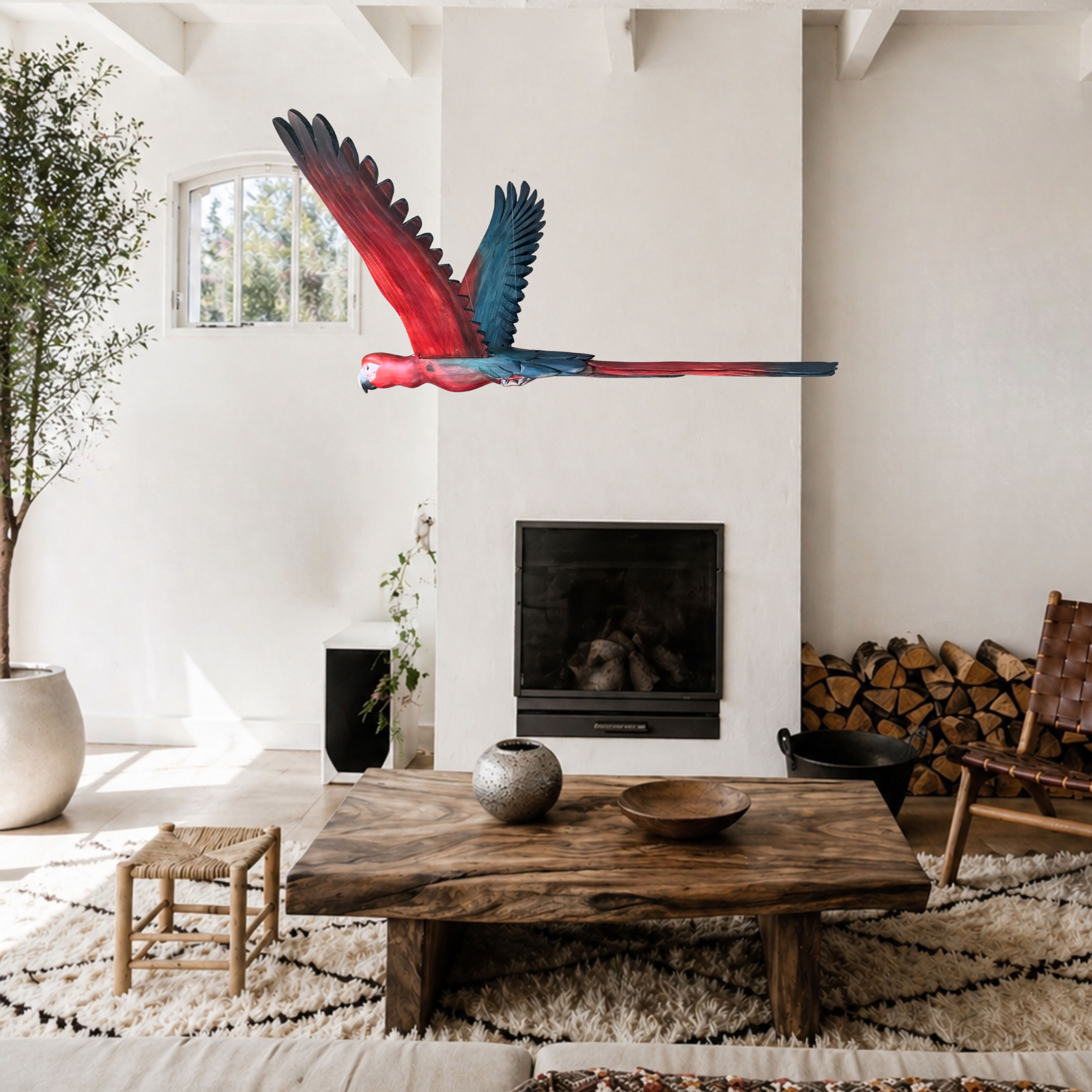 Hand-carved Scarlet Macaw flying bird sculpture suspended in a double-volume living room
