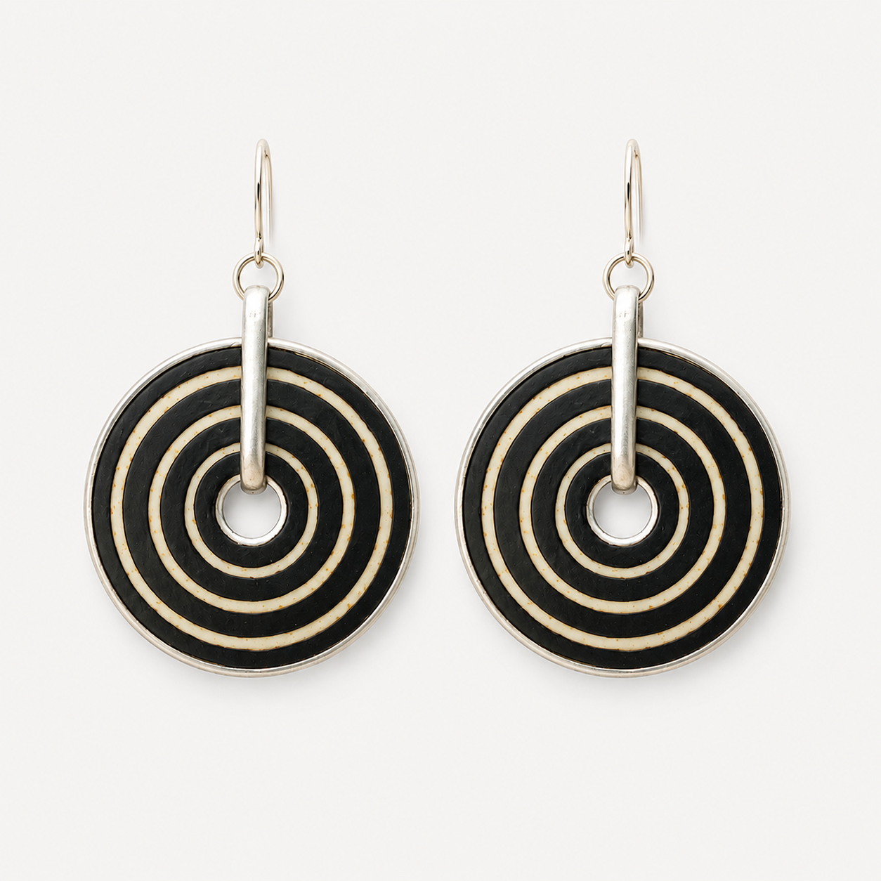 Handcrafted black and white ostrich eggshell statement earrings with hand-painted concentric circles and stainless steel hooks.