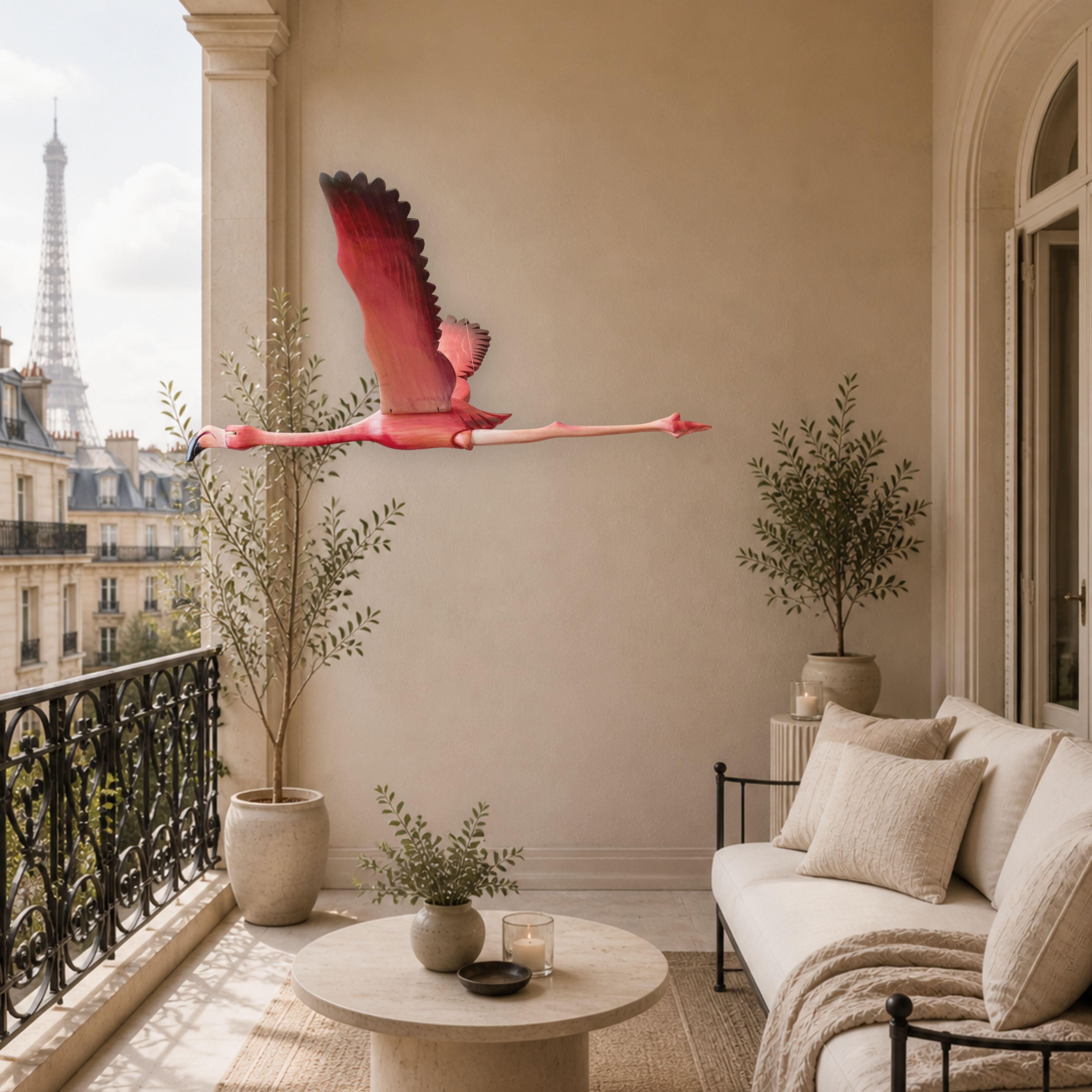 A veranda in Paris with a hand-carved pink flamingo mobile in flight , beige sofa, and Eiffel Tower view.