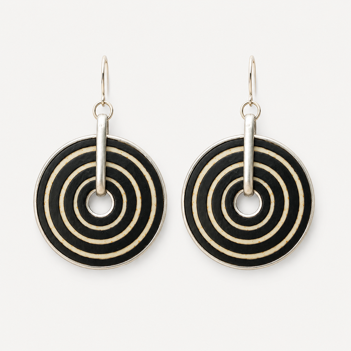 Handcrafted black and white ostrich eggshell statement earrings with hand-painted concentric circles and stainless steel hooks.