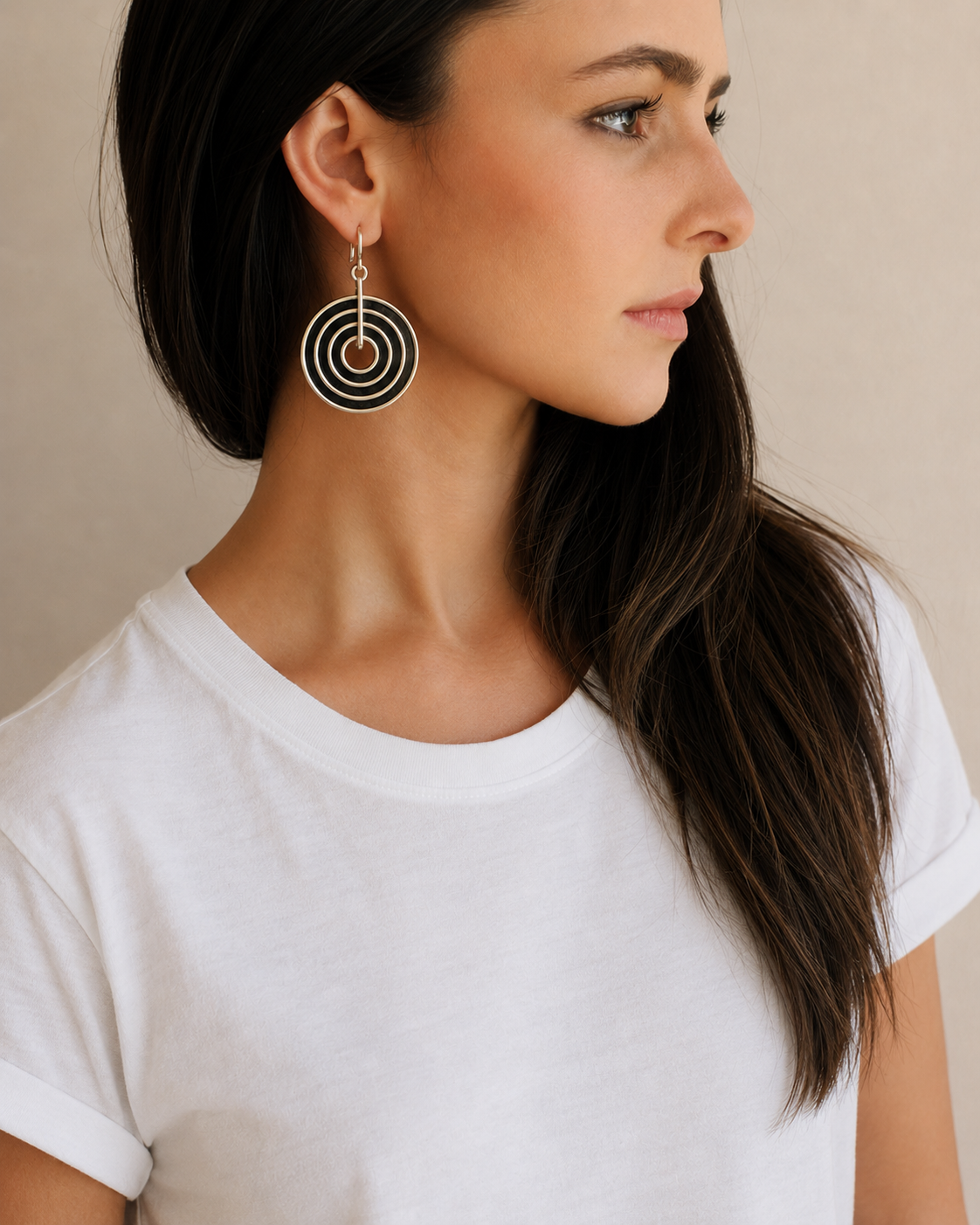 Side profile of model wearing contemporary black and white ostrich eggshell statement earrings handcrafted in South Africa.
