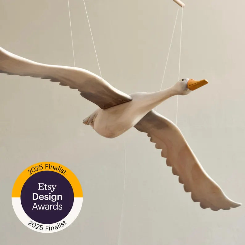 Wooden Goose mobile  in flight with '2025 Etsy Design Awards Finalist' badge 