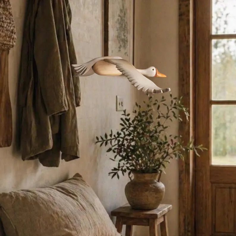 Decorative hand carved goose mobile in a rustic entrance hall